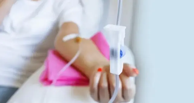 IV line taped to a patient's hand