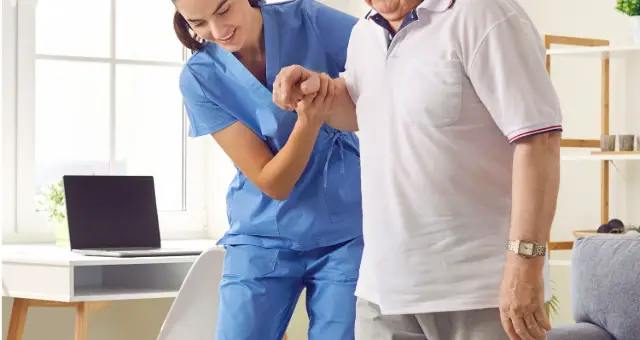 Nurse walking with an older man at home