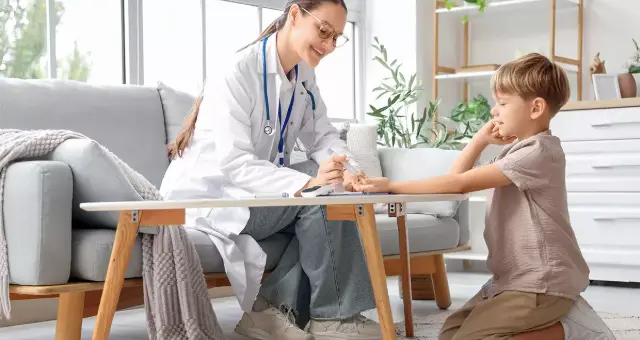 Doctor checking a child at home