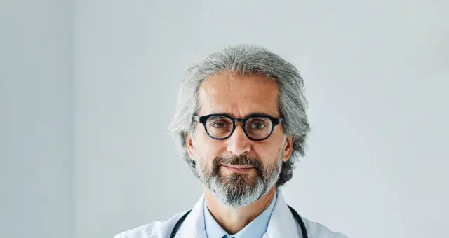 Senior doctor with a stethoscope smiling