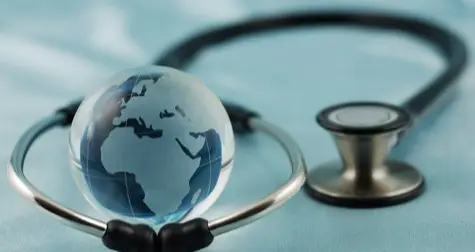 Stethoscope around a small globe