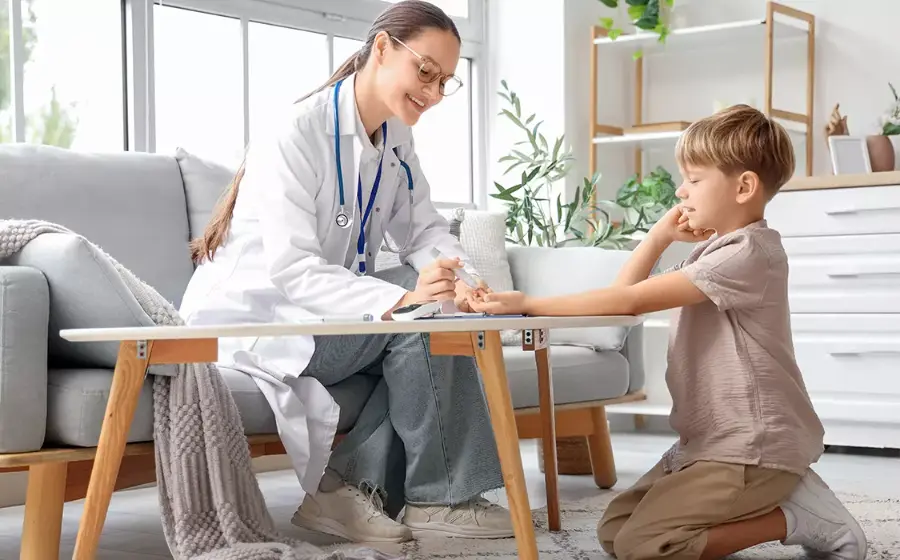 Doctor visiting a mother and child in their living room