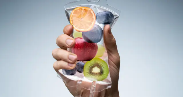 Hand holding an IV vitamin drip bag