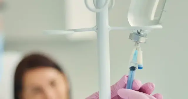 Nurse adjusting an IV drip line