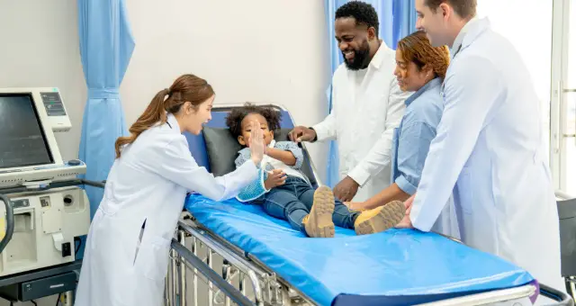 Medical team attending to a patient in bed